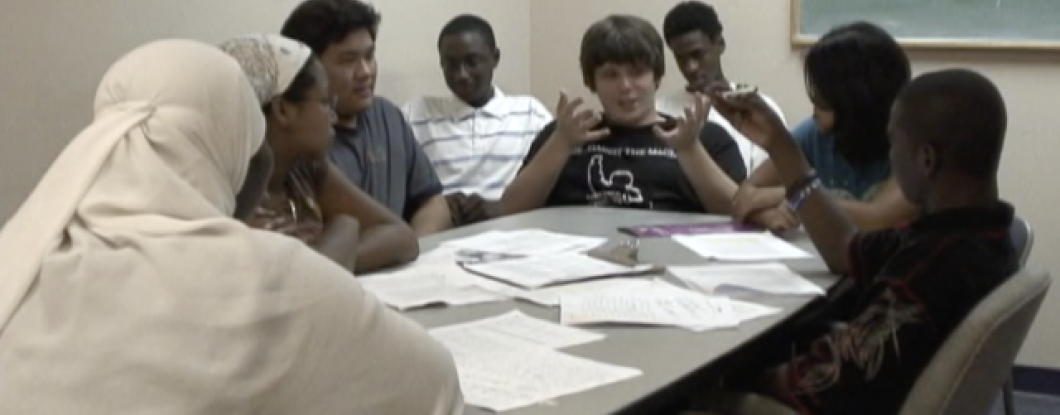 A group of students sitting around a table talking
