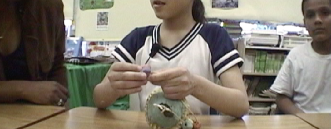 A Girl in a Classroom working on a clay sculpture