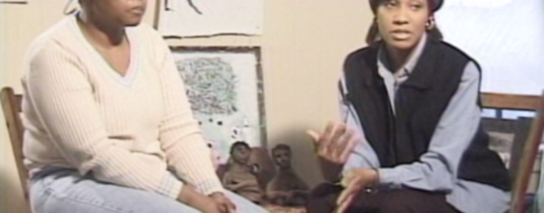 Two women sitting, talking in a room