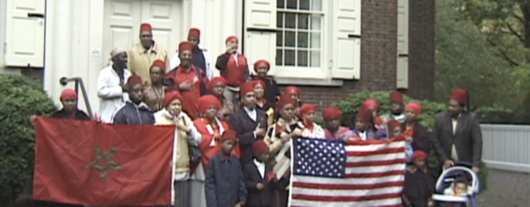 Members of the Moorish Science Temple hold flags 