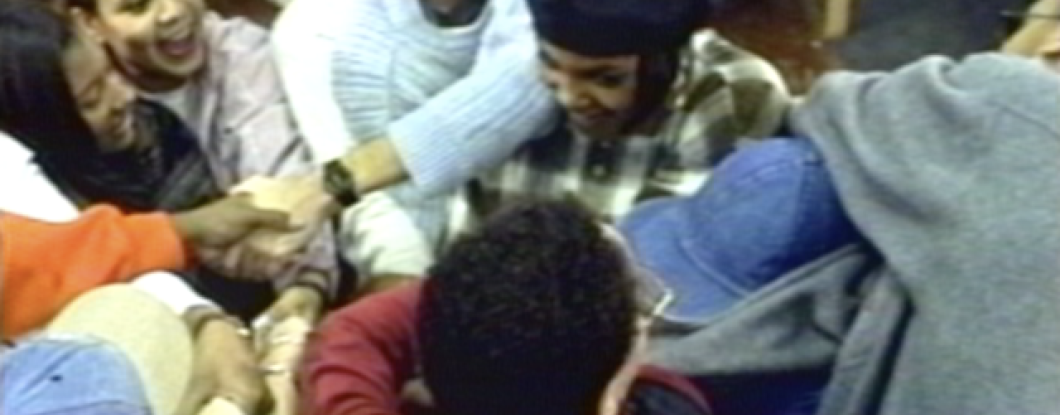 A group of people holding hands in a circle