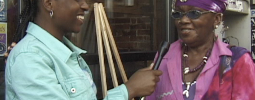 A young woman interviewing a middle aged woman on the street 