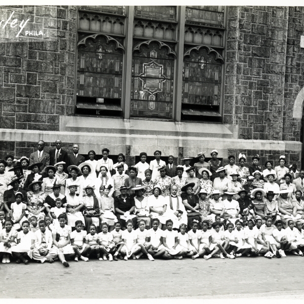 church members standing in front of church posing for a group photo