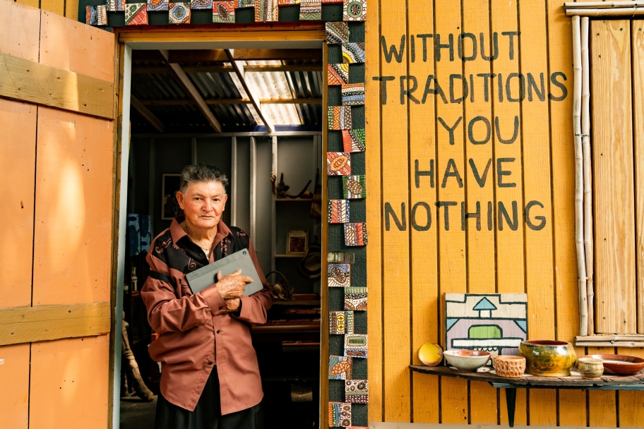 person standing in door beside the words " Without traditions you have nothing"