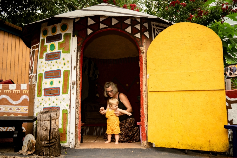 child and woman in hut