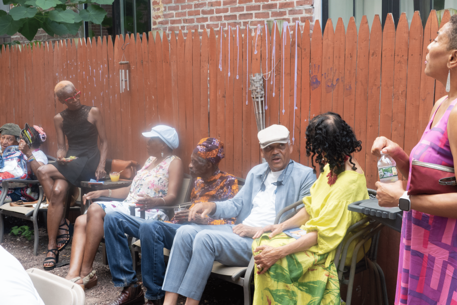 people sitting by fence
