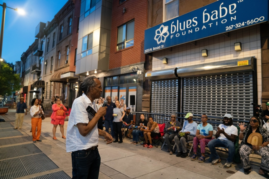 Louis Massiah speaking to guests