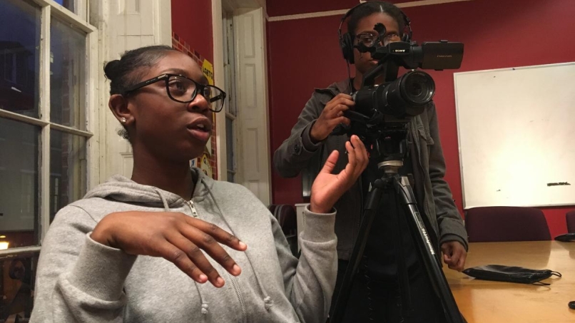 Two students filming