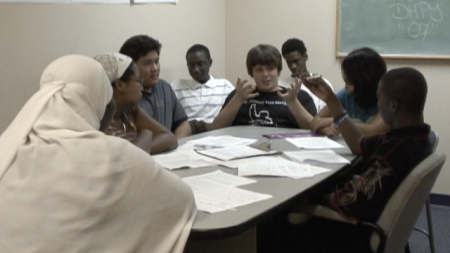 A group of students sitting around a table talking