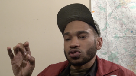 A man speaks to the camera in an interview