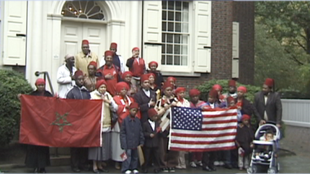 Members of the Moorish Science Temple hold flags 