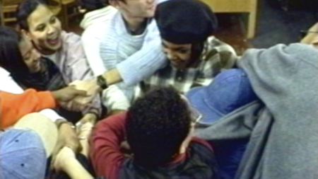 A group of people holding hands in a circle