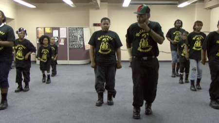 A group of people in a step team dancing
