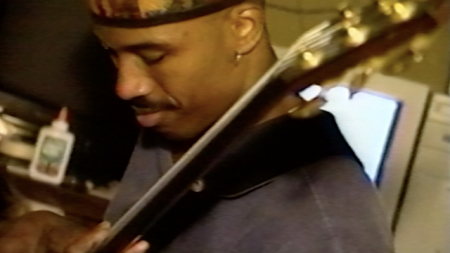 Rubin Edwards playing bass guitar